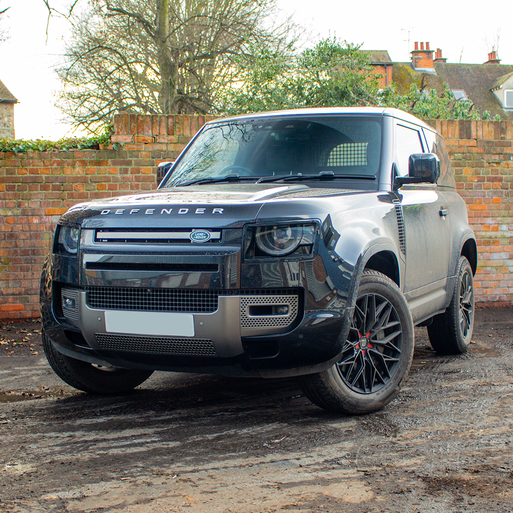 Land Rover Defender L663 on aftermarket alloy wheels parked on a driveway.