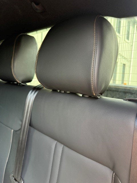 Close-up of two rear headrests on the Ford Ranger 2-Seat Commercial rear seat conversion, showing the contrast stitching and the seatbelt webbing behind