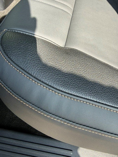 Close-up of the leather grain and contrast stitching on the seat bolster of the Ford Ranger 2-Seat Commercial rear seat conversion